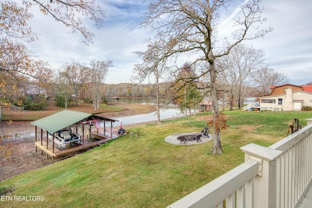 view of yard with a water view and a fire pit