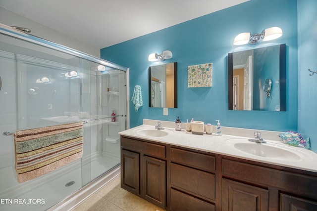 bathroom with tile patterned flooring, vanity, and an enclosed shower