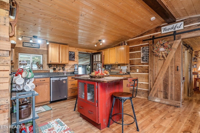 kitchen with light wood-type flooring, a center island, lofted ceiling with beams, and stainless steel dishwasher