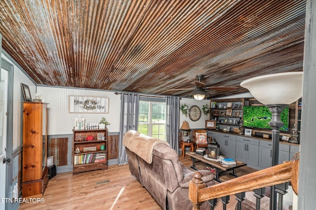 living room featuring wood walls and light wood-type flooring