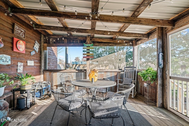 sunroom / solarium featuring beamed ceiling and a wealth of natural light