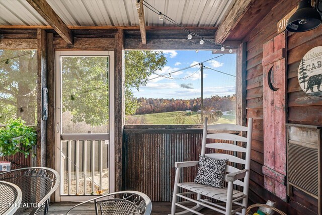 unfurnished sunroom featuring beamed ceiling and wood ceiling