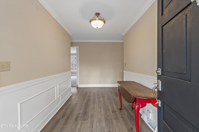 entryway with wood-type flooring and ornamental molding