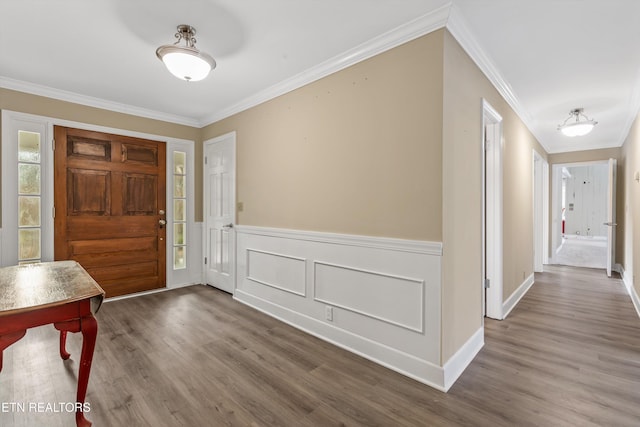 entrance foyer featuring wood-type flooring and ornamental molding