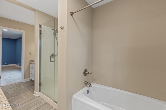 bathroom with vanity and shower with separate bathtub