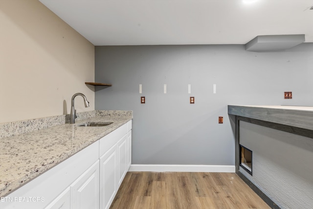 laundry area featuring sink and light wood-type flooring