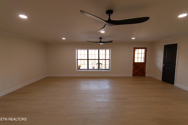 unfurnished living room featuring light hardwood / wood-style flooring, ceiling fan, and ornamental molding