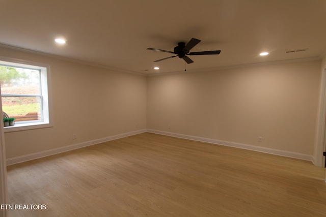 empty room featuring light hardwood / wood-style floors, ceiling fan, and crown molding