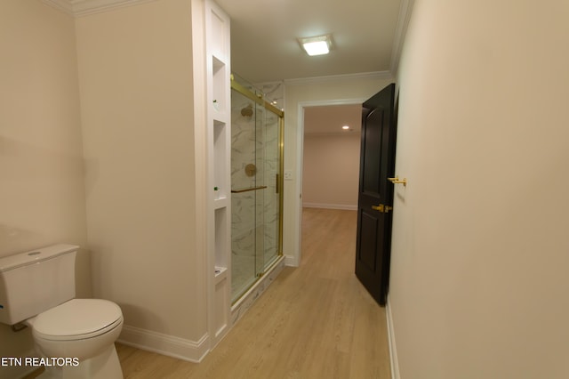 bathroom with hardwood / wood-style floors, walk in shower, and ornamental molding