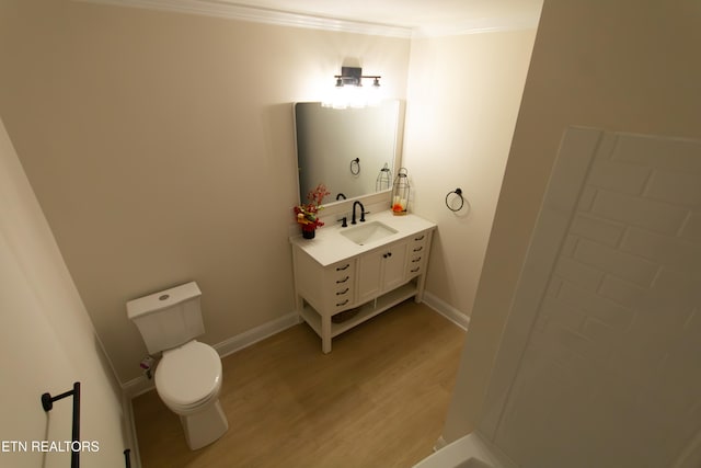 bathroom featuring hardwood / wood-style floors, vanity, toilet, and crown molding