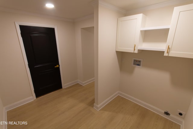 washroom featuring cabinets, ornamental molding, hookup for a washing machine, and light hardwood / wood-style flooring