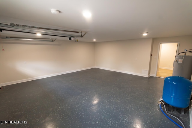 garage featuring water heater and a garage door opener