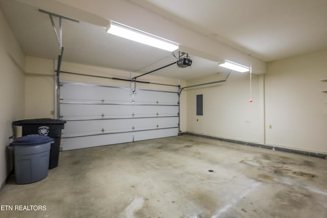 garage featuring electric panel and a garage door opener