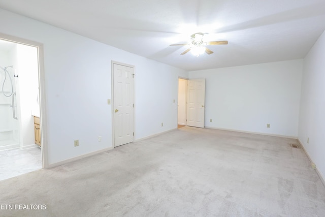 spare room with light carpet and ceiling fan