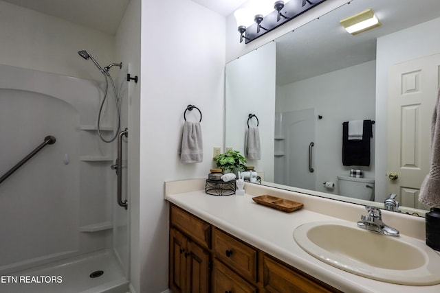 bathroom with vanity, toilet, and walk in shower