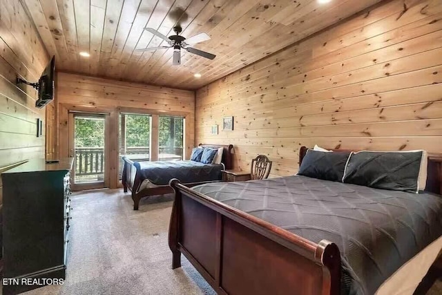 carpeted bedroom featuring wood ceiling, access to outside, vaulted ceiling, ceiling fan, and wood walls