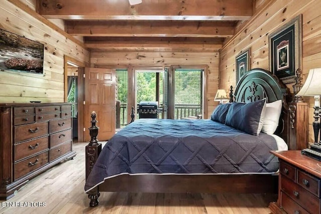 bedroom featuring access to exterior, wood walls, light hardwood / wood-style flooring, and beamed ceiling