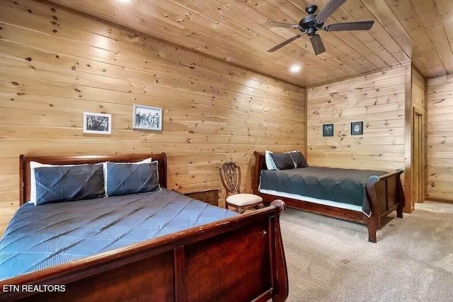 unfurnished bedroom featuring ceiling fan, light colored carpet, wood walls, and wooden ceiling