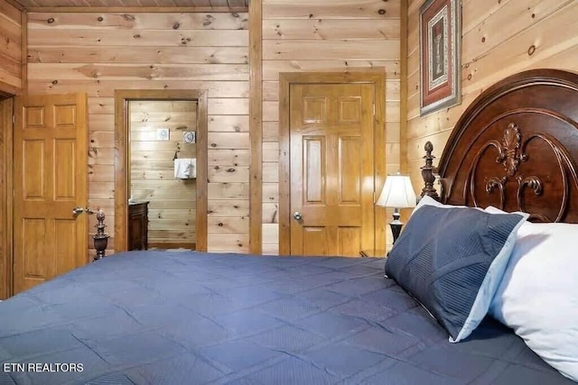 bedroom featuring wooden walls