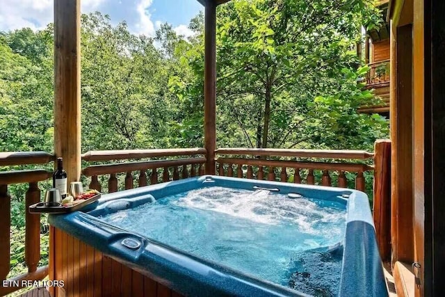 wooden terrace featuring a hot tub