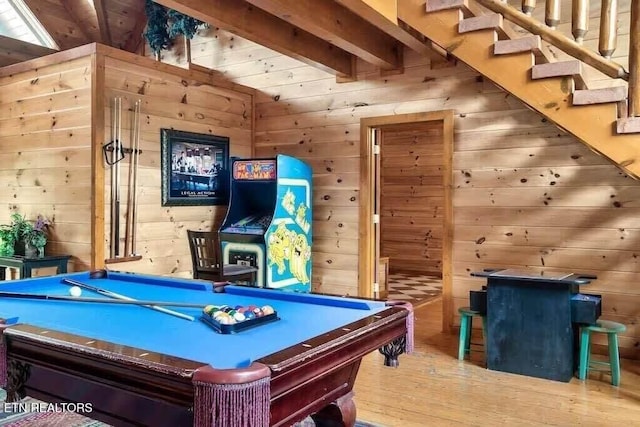 rec room featuring beam ceiling, hardwood / wood-style flooring, wooden walls, and billiards