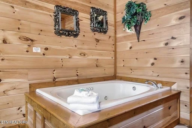 bathroom featuring a bathing tub and wooden walls