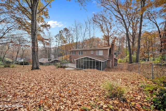 rear view of property with a sunroom