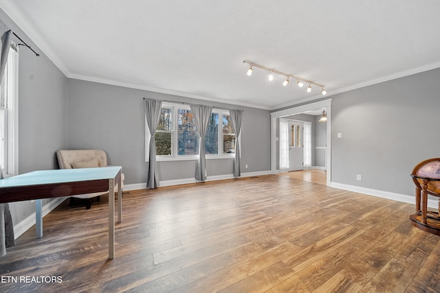 living area featuring hardwood / wood-style flooring and crown molding