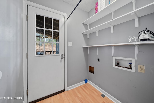 clothes washing area with washer hookup, hardwood / wood-style floors, and electric dryer hookup