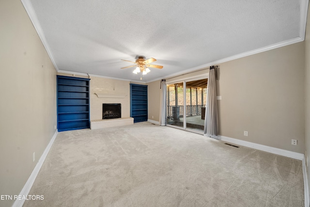 unfurnished living room featuring ornamental molding, a fireplace, carpet, and a textured ceiling