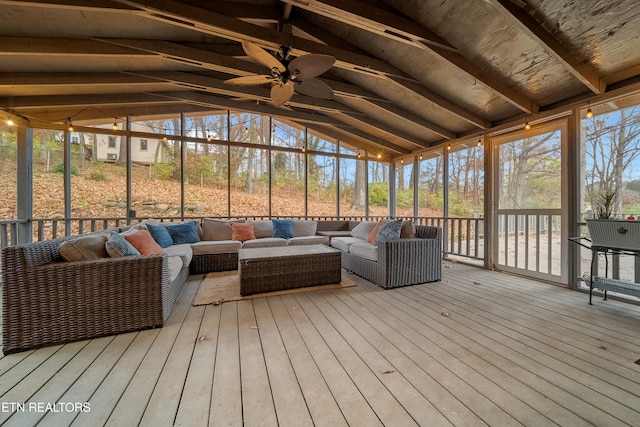 sunroom / solarium with lofted ceiling with beams and ceiling fan