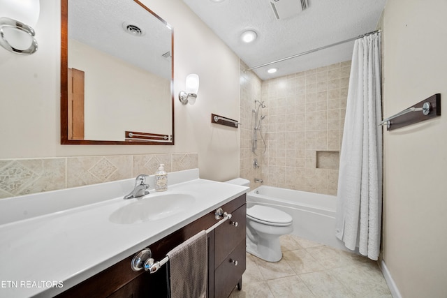 full bathroom with shower / bathtub combination with curtain, vanity, a textured ceiling, tile patterned floors, and toilet