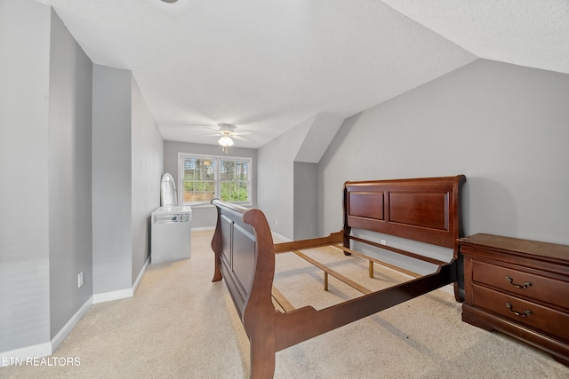 carpeted bedroom featuring ceiling fan, vaulted ceiling, and a textured ceiling