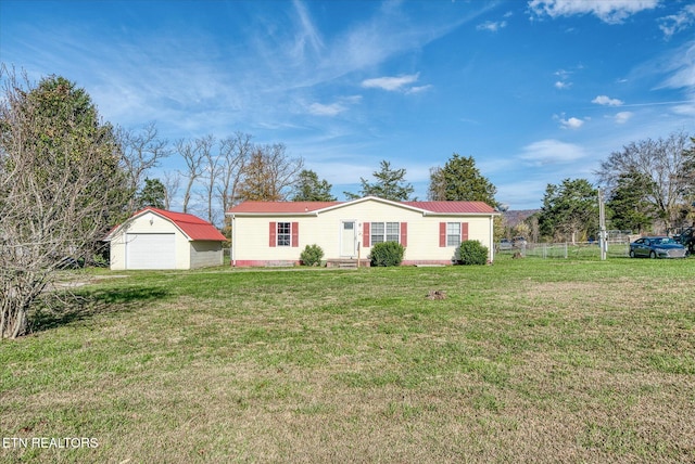 view of front of house featuring an outbuilding, a front lawn, and a garage