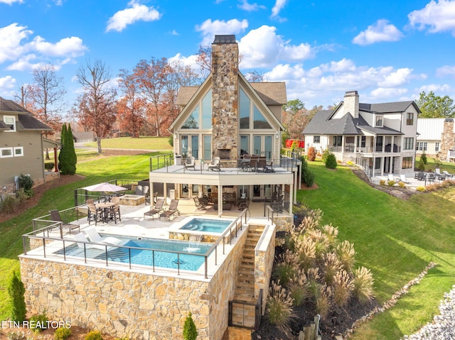 back of house featuring a swimming pool with hot tub, a yard, and a patio area