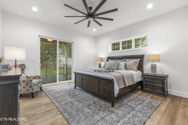 bedroom with access to exterior, light hardwood / wood-style floors, multiple windows, and ceiling fan