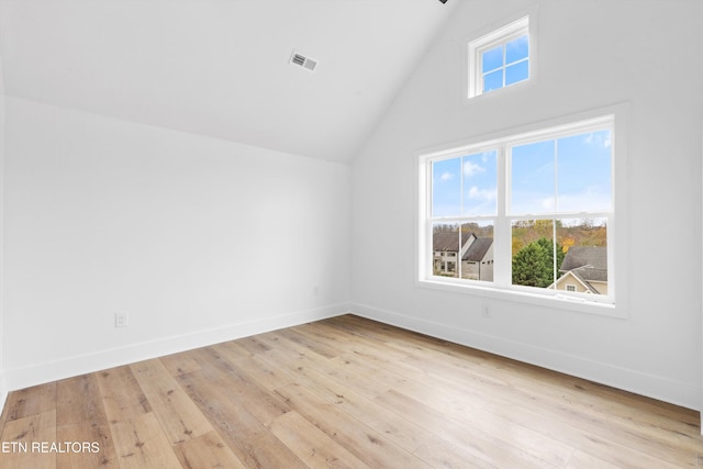 bonus room with light hardwood / wood-style floors and lofted ceiling