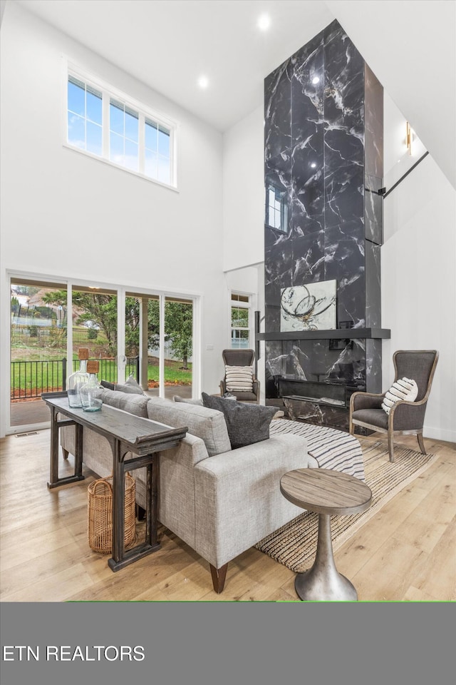 living room with a wealth of natural light and hardwood / wood-style flooring