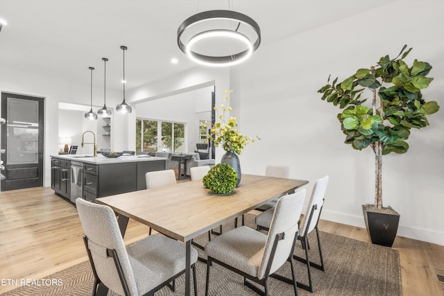 dining area featuring light hardwood / wood-style floors and sink