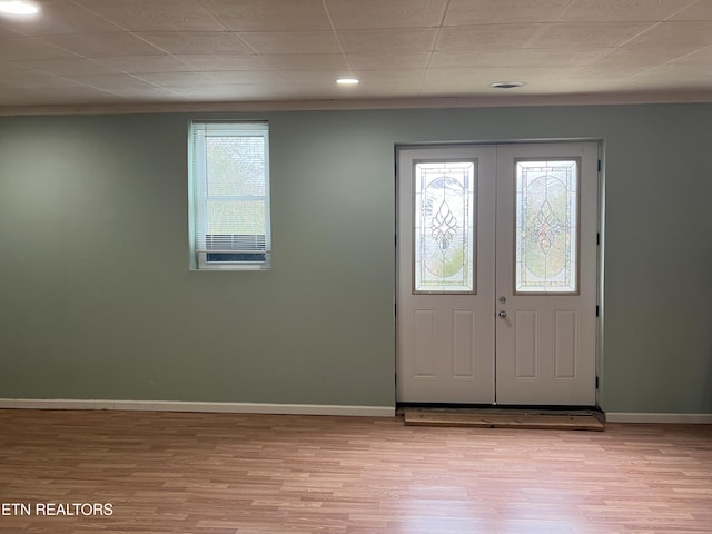 foyer entrance with light hardwood / wood-style flooring, a healthy amount of sunlight, and french doors