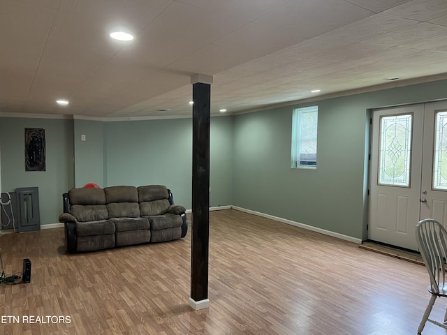 living room featuring light hardwood / wood-style flooring and ornamental molding