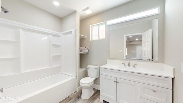 full bathroom with vanity, hardwood / wood-style flooring, toilet, and shower / washtub combination