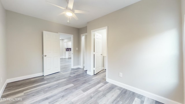 spare room with light hardwood / wood-style floors and ceiling fan