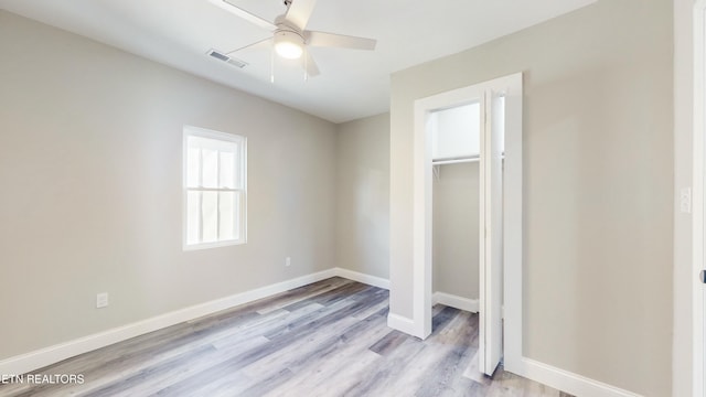 unfurnished bedroom with ceiling fan, a closet, and light hardwood / wood-style flooring