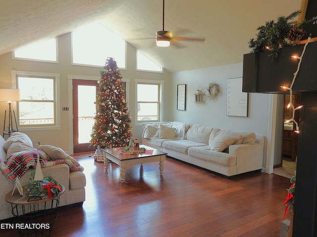 living room featuring ceiling fan, a healthy amount of sunlight, dark wood-type flooring, and high vaulted ceiling