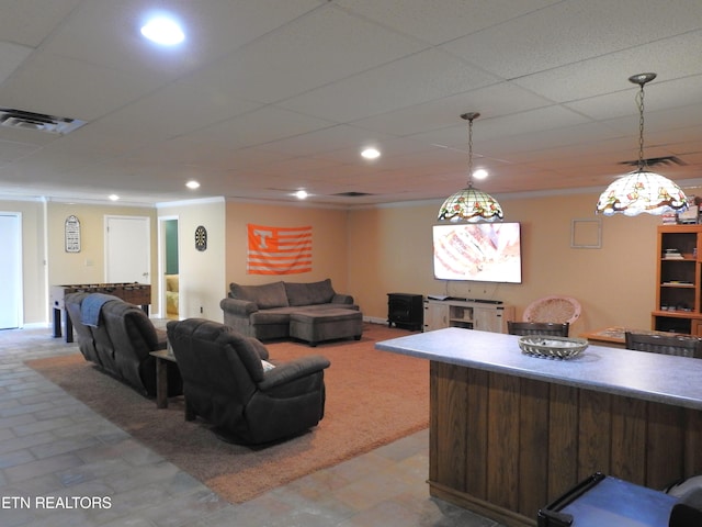 living room featuring bar and ornamental molding