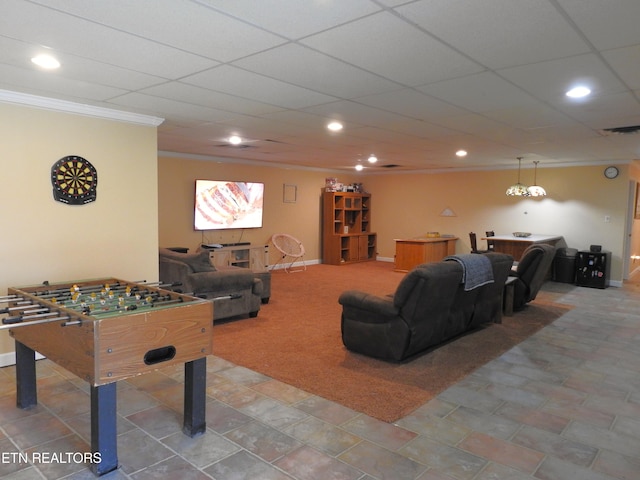 recreation room with a drop ceiling and crown molding