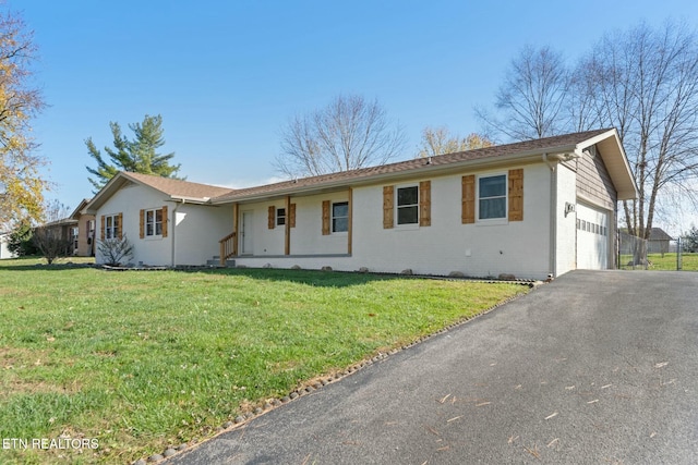 single story home featuring a garage and a front lawn