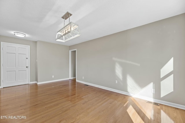 unfurnished room with hardwood / wood-style floors