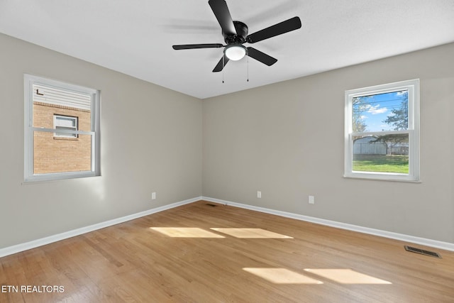 spare room featuring hardwood / wood-style floors and ceiling fan